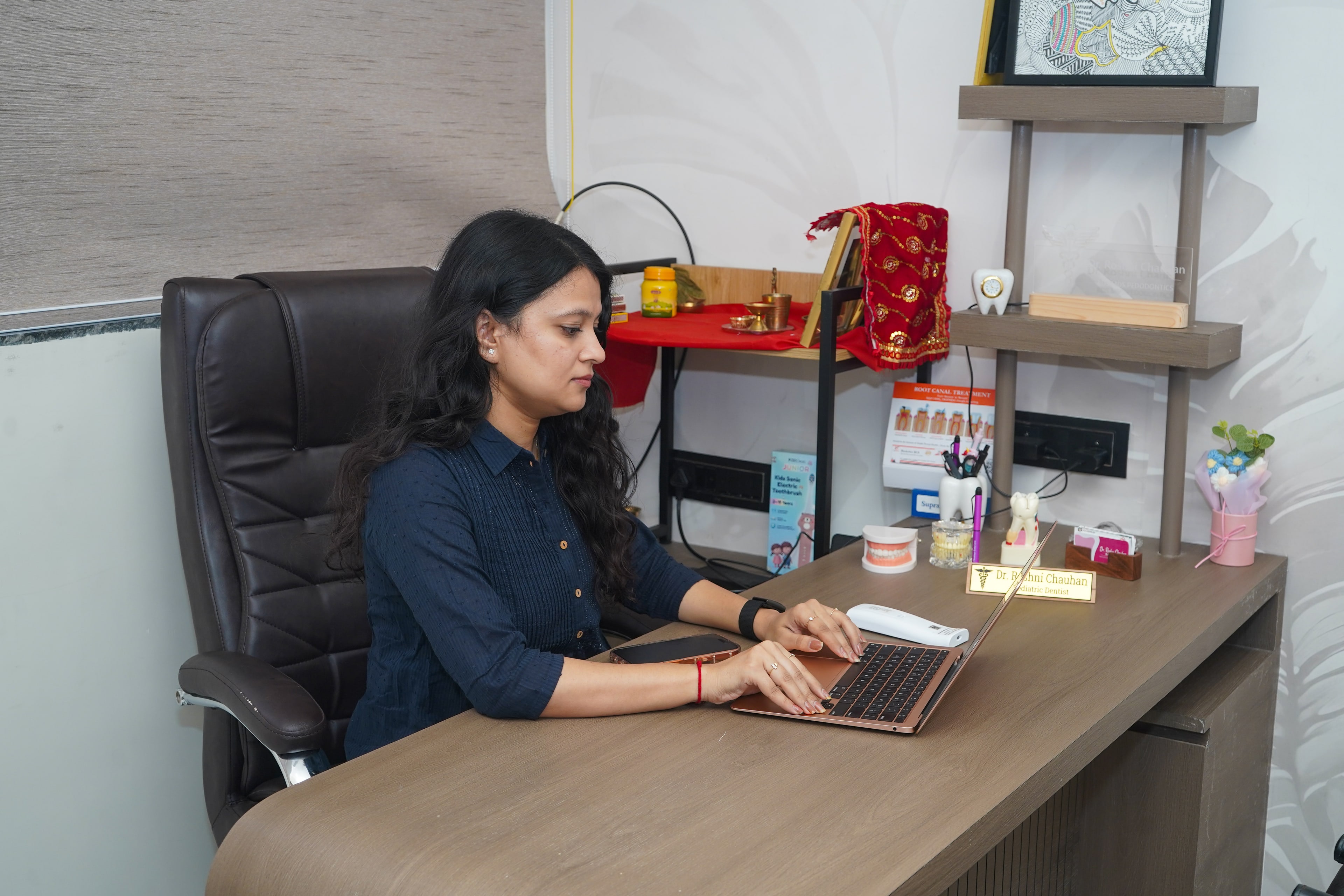 Dr. Roshni Chauhan at the consultation-room desk